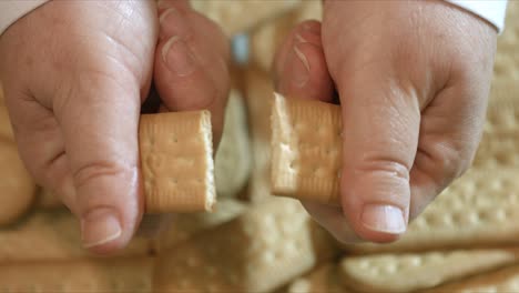 Close-up-of-Female-hands-breaking-a-cornstarch-wafer-in-half