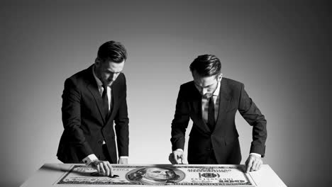 businessmen analyzing a large dollar bill