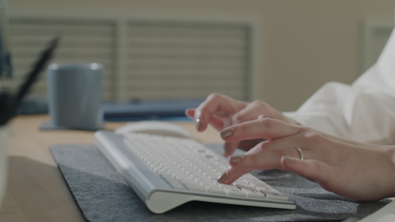 Woman typing on a keyboard in a modern office