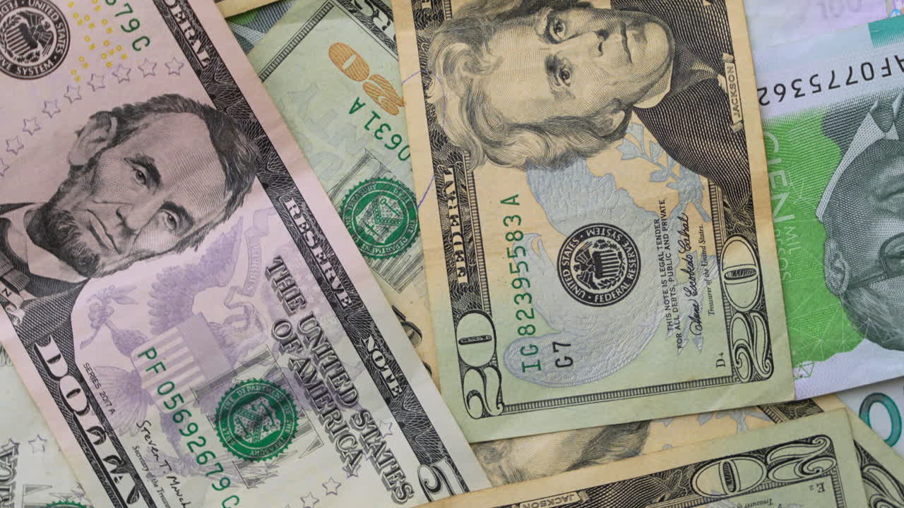 Detailed view of US dollars and Colombian pesos currency notes showcasing vibrant colors and intricate designs. Perfect for finance, business visuals. Lighting highlights textures