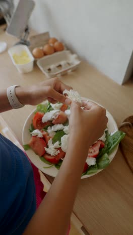 preparing a mozzarella and tomato salad