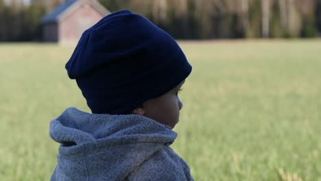 close shot of cute toddler in rural field