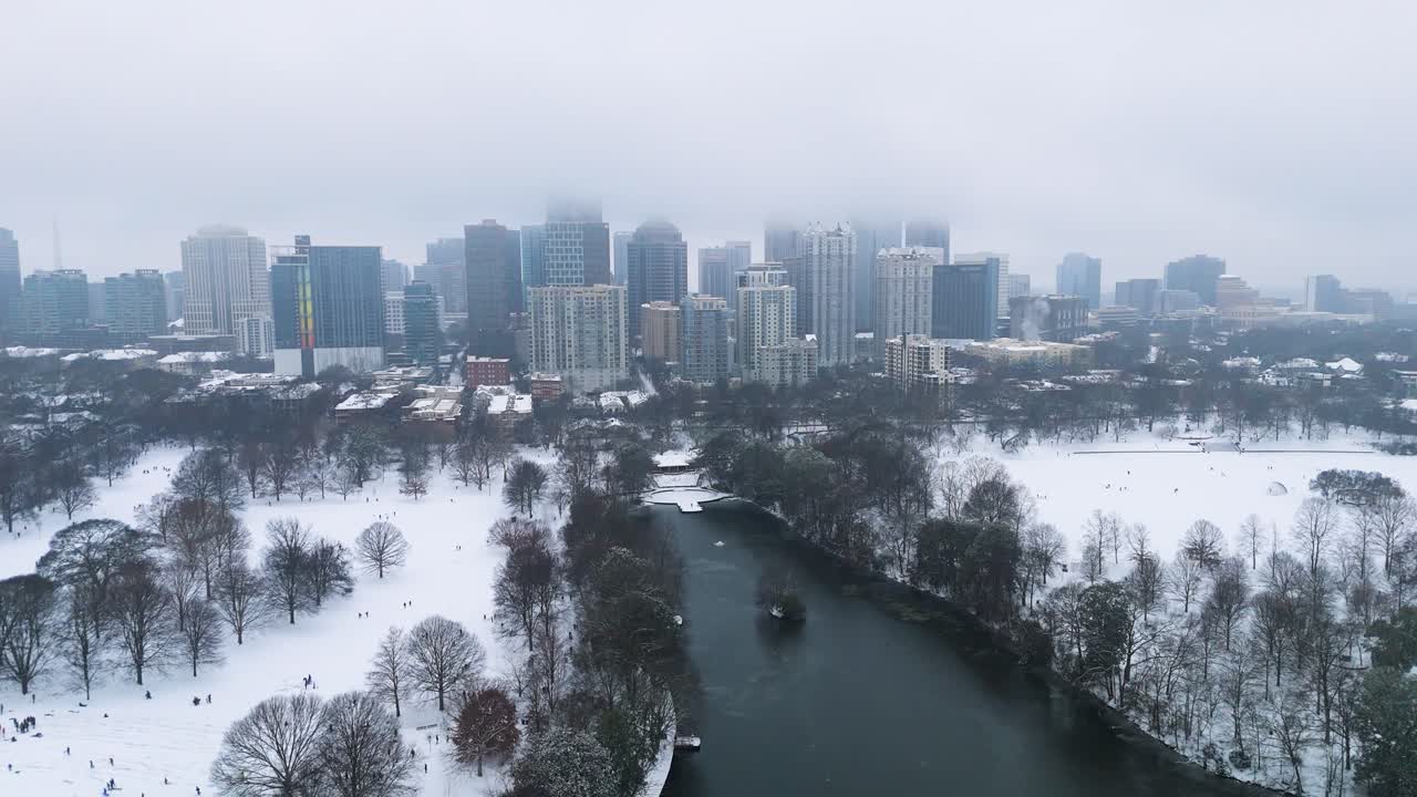 Aerial shot pulling out from snow covered Midtown and Piedmont Park in Atlanta on January 10th 2025.