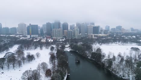 aerial shot pulling out from snow covered midtown and piedmont park in atlanta on january 10th 2025.