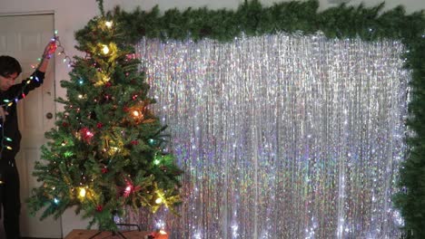 christmas tree decorations, with a backdrop of shimmering silver streamers as home decor