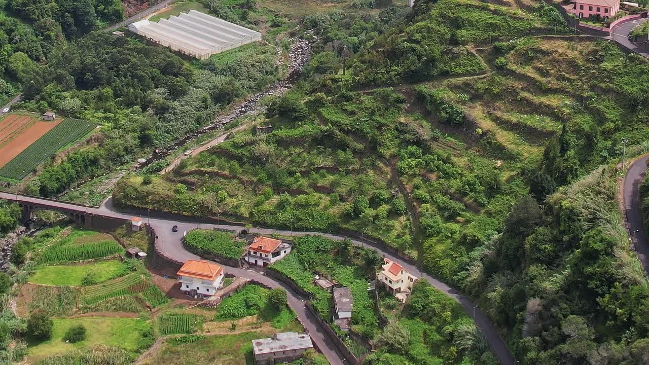 Scenic aerial view of lush Madeira landscape with river and fields