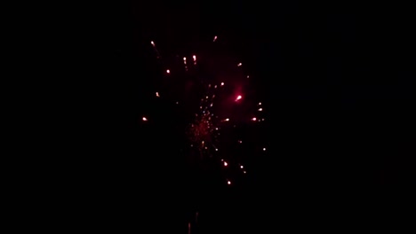 fireworks display on dark night sky in slow motion handheld blur