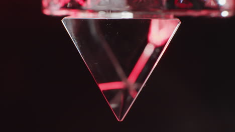 close-up of a triangular prism with red lighting