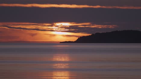 a silhouette of the ferries drifts slowly under a soft-hued sky, while the peaceful evening air colors the water in gentle tones.