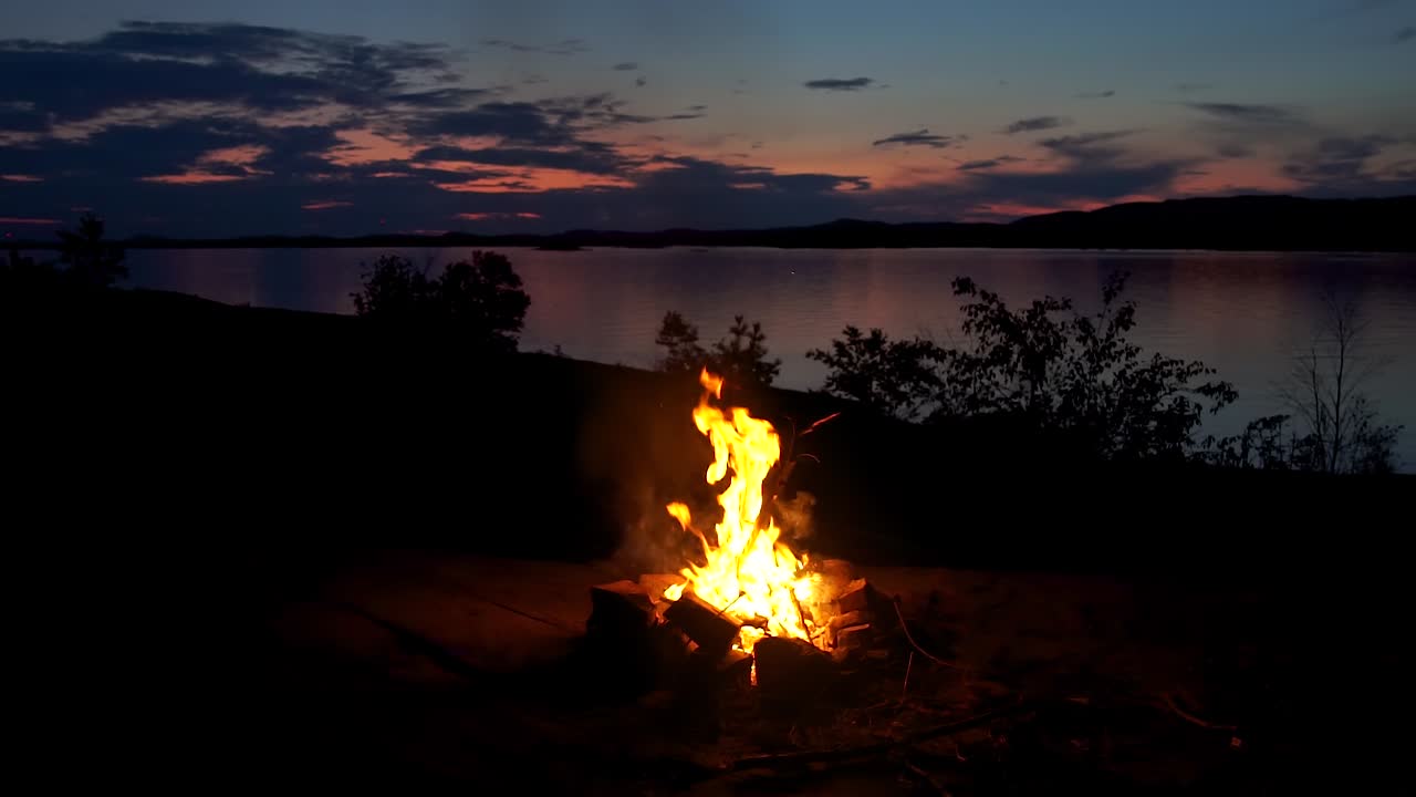 Philip Edward, Island, Ontario, Canada -  Bonfire in the lake at dusk with lovely scenery - Wide shot
