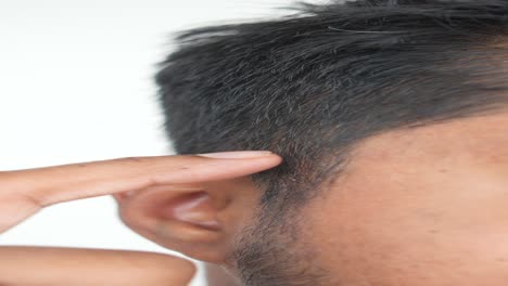 close up of a man touching his ear