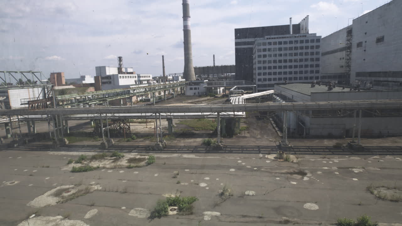 The Abandoned Structures of the Chernobyl Reactor Complex Stand Silent and Overgrown - Aerial Wide Shot