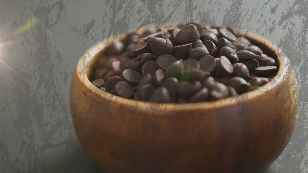 Animazione di luce su cioccolatini croccanti in una ciotola su sfondo grigio