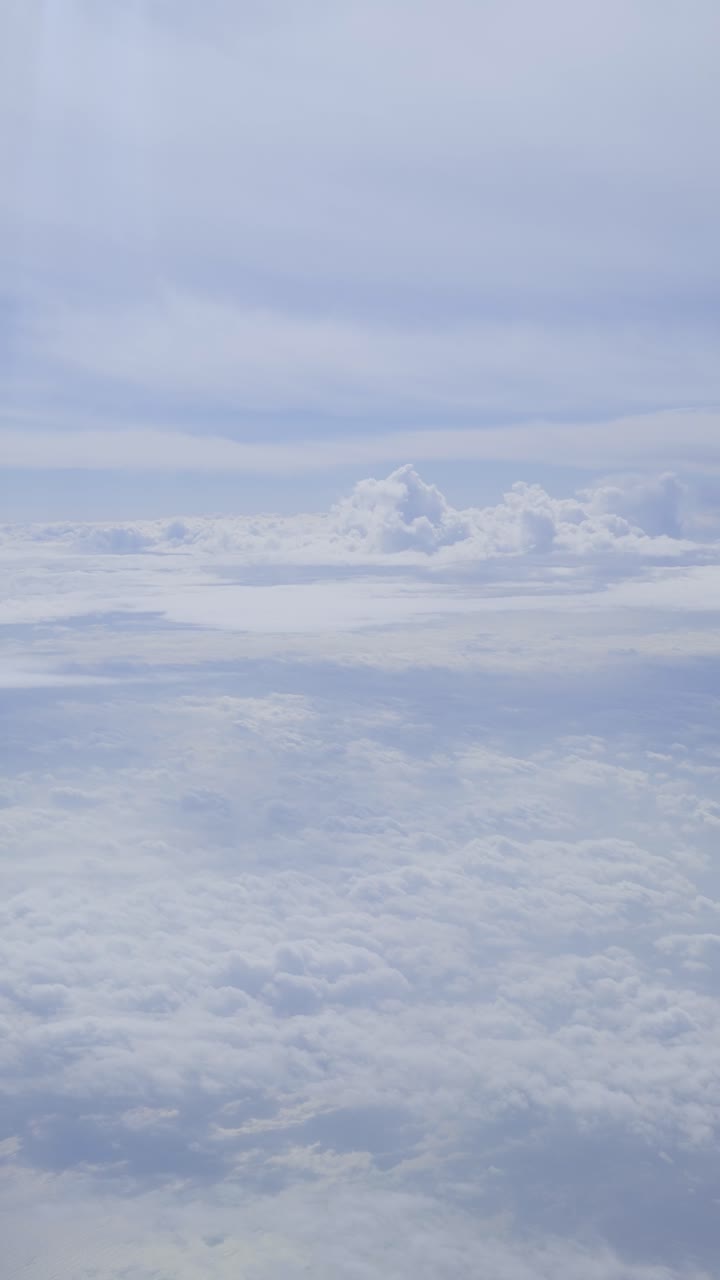 Cloudy sky from above, view from an airplane window, soft light, calm atmosphere