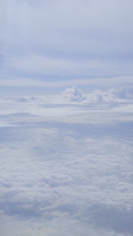 cloudy sky from above, view from an airplane window, soft light, calm atmosphere