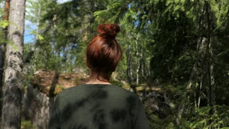 Woman-walking-forest-path,-wandering-in-green-nature