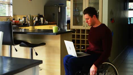 Disabled-man-having-coffee-while-using-laptop-4k