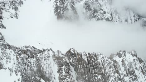 Aerial-View-of-Snow-Capped-Hills-and-Peaks-of-Alps-on-Cold-Winter-Day