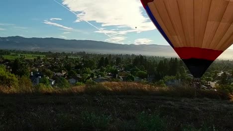 WS-of-the-wine-region-Napa-Valley,-California-as-three-hot-air-balloons-are-descending-to-land