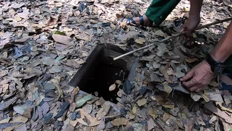 camouflaged manhole opening at cu chi tunnels