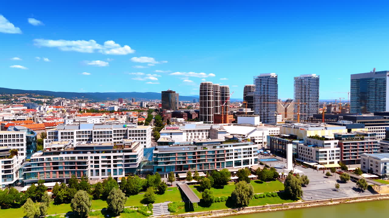 Bratislava's modern skyline. A vibrant view of Bratislava's urban landscape showcasing buildings, greenery, and clear blue skies in summer