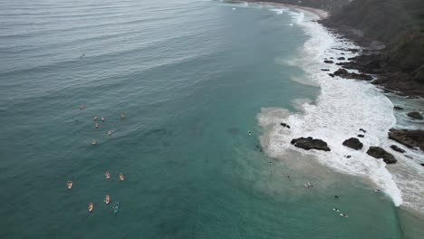 The-Pass-Beach-With-Surfers-In-NSW,-Australia---Aerial-Drone-Shot