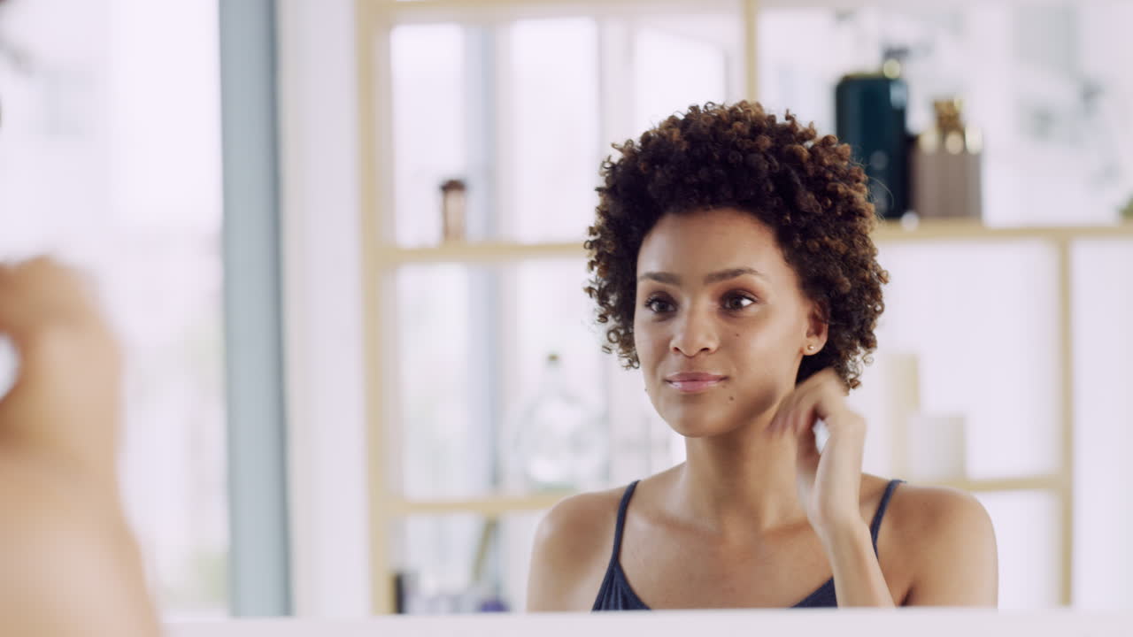 Woman Applying Makeup and Skincare in Bathroom