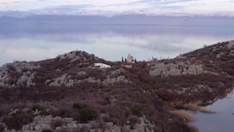 aerial-view-of-Beska-islet-and-its-monastery-in-Lake-Skadar,-Montenegrin-municipality-of-Bar