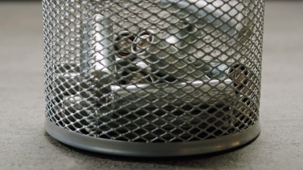 Silver batteries AA and AAA falling into water close-up. Double-A battery is a standard size single cell cylindrical dry battery. Batteries are common in portable electronic devices. Environmental impacts of lithium-ion batteries concept. An AA battery is composed of a single electrochemical cell th