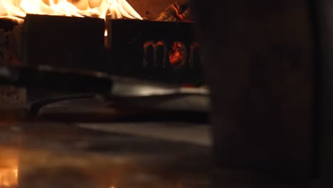 cooking pizza in a wood-fired oven