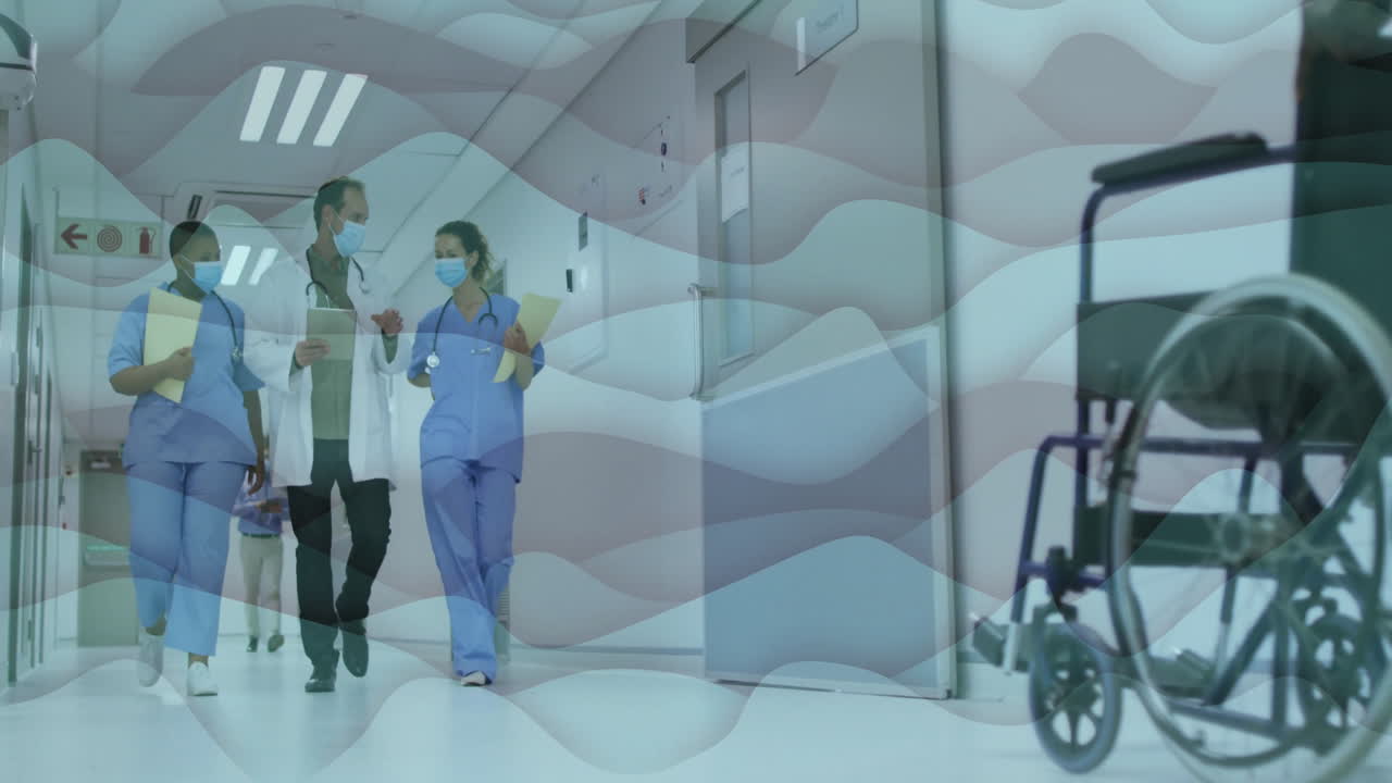 Medical team walking hospital corridor, tablet displaying animated health chart with floating icons