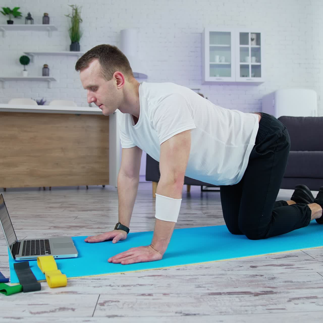 Young lifestyle sportsman working out at home. Training body indoor by strong handsome man
