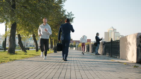 people walking in a city park on a sunny day