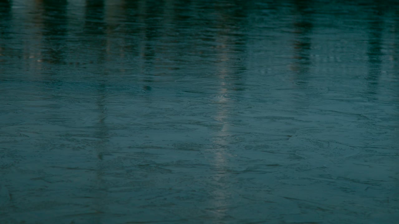 Close up view of a frozen lake shiny surface with a reflection