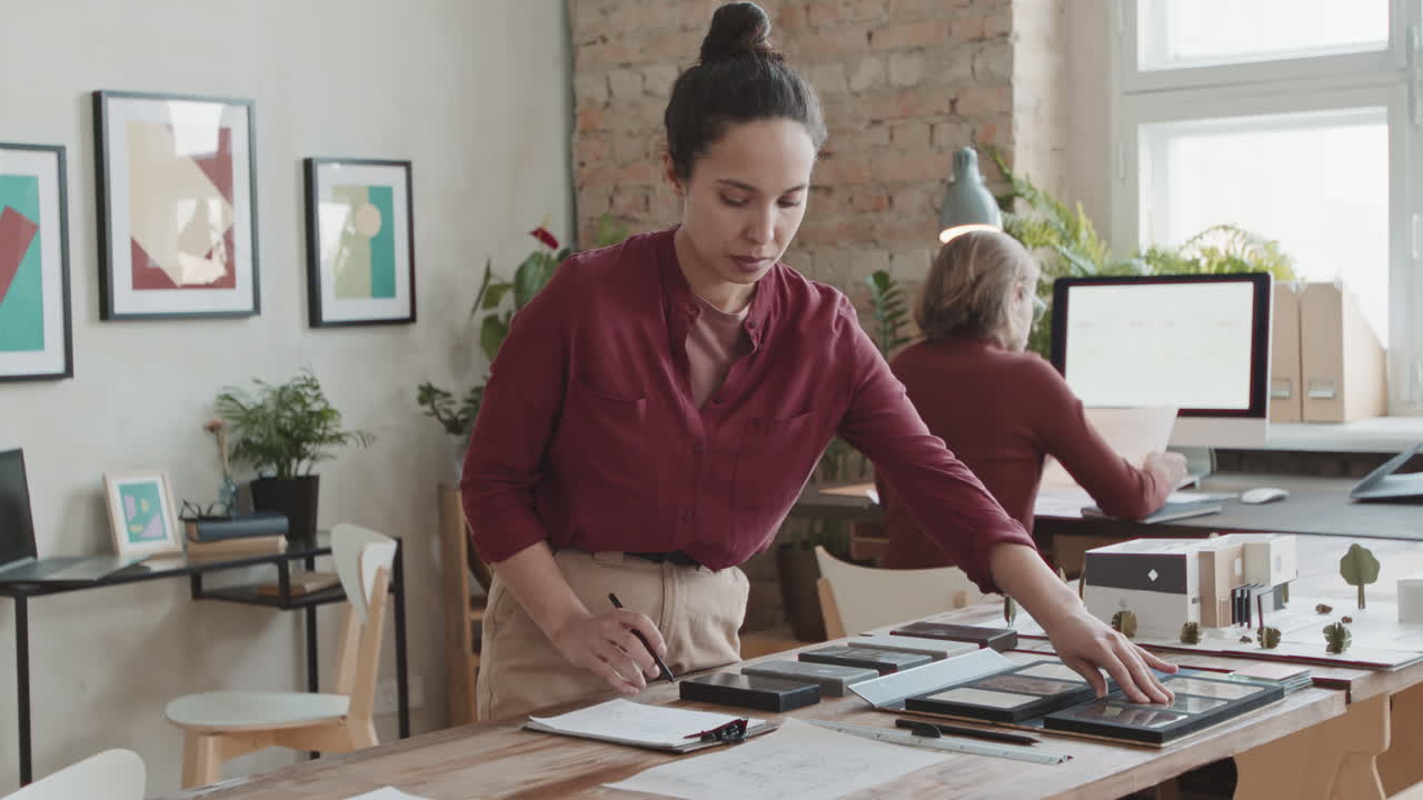 Female Architect Choosing Building Material For New House