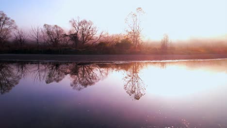 Drone-flying-over-Eagle-creek-on-foggy-day,-Indiana