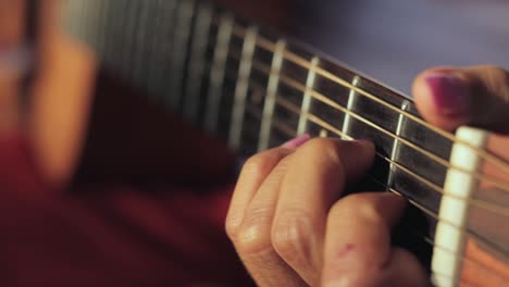 female guitarist playing guitar. - close up