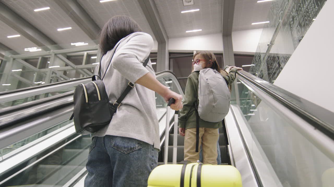Woman With Kids On Airport Escalator