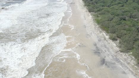 Waves-Hitting-The-Coastal-Borders-And-Forest-Edge-Of-NSW-Border-Creek,-In-Queensland,-Australia