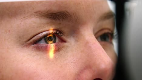 female patient undergoing eye examination on slit lamp