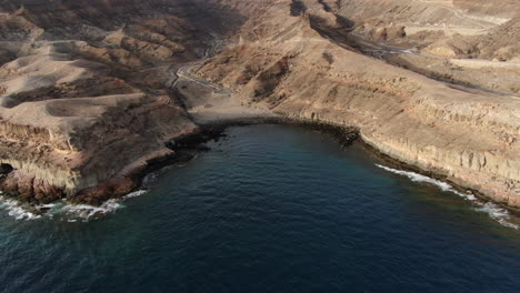 Drone-shot-at-sunset-of-the-Medio-Almud-beach,-on-the-island-of-Gran-Canaria,-Mogán