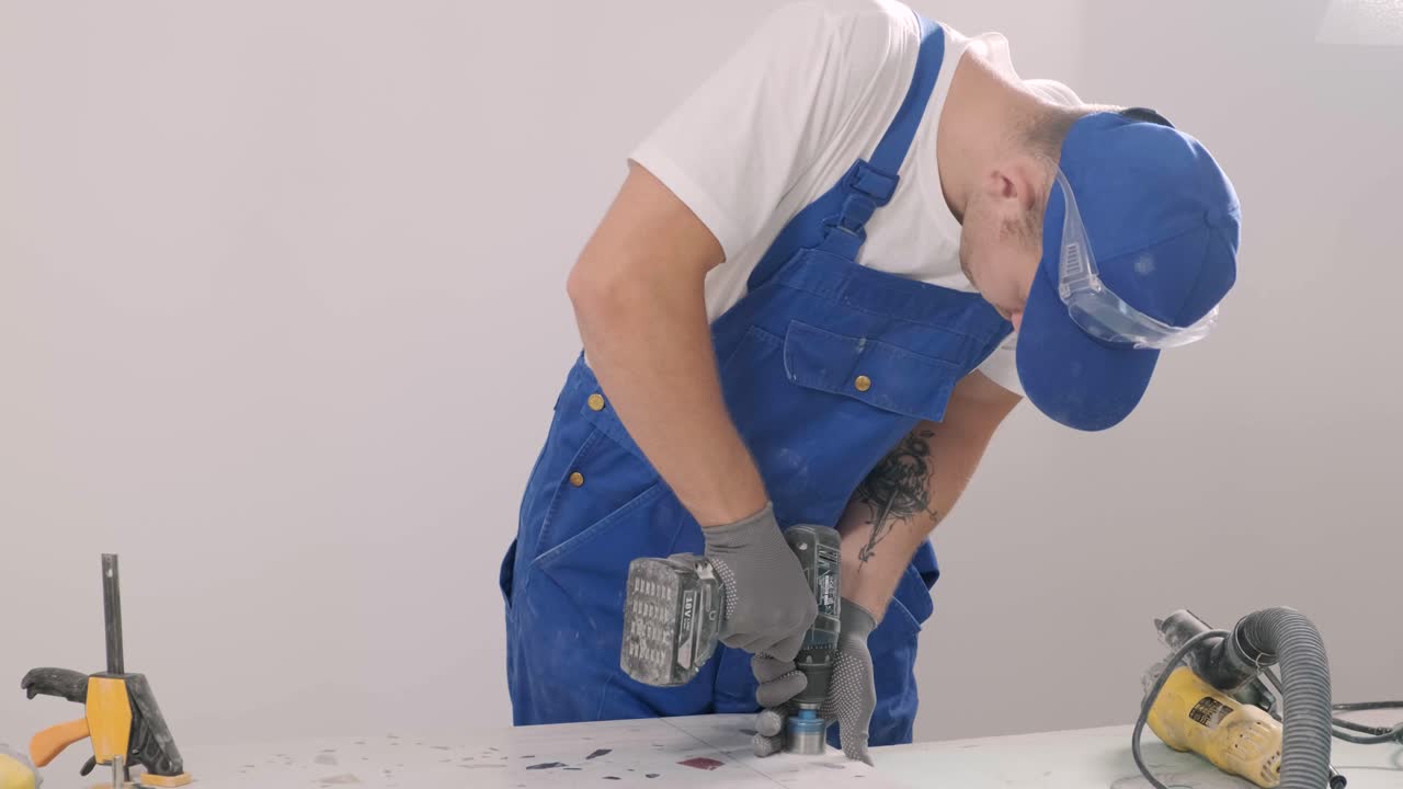Installing ceramic floor tiles - measuring and cutting the pieces. Construction, renovation, repair apartment. Cuts tile. Tile cutting