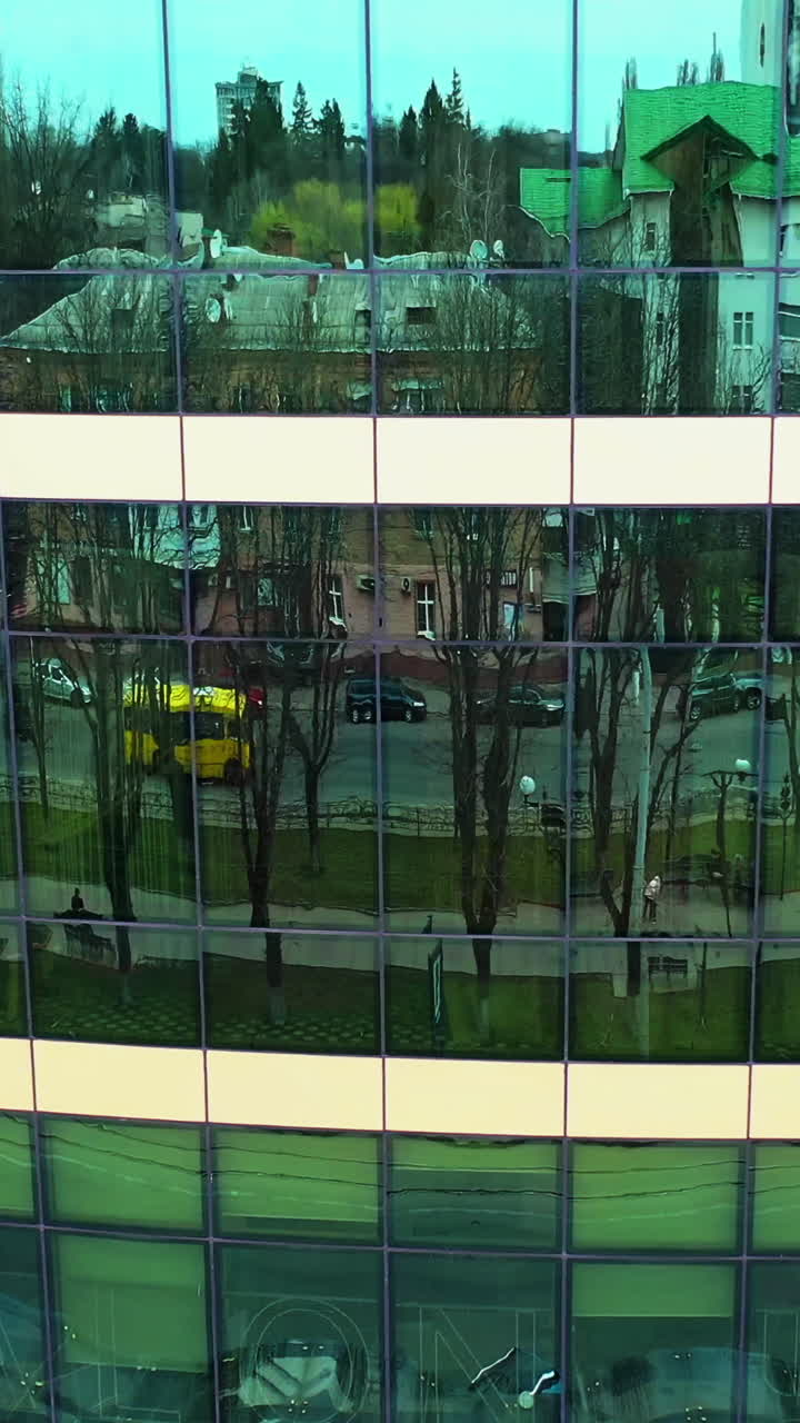 Windows of skyscraper building. Modern office skyscraper with glass windows and reflection. Vertical video