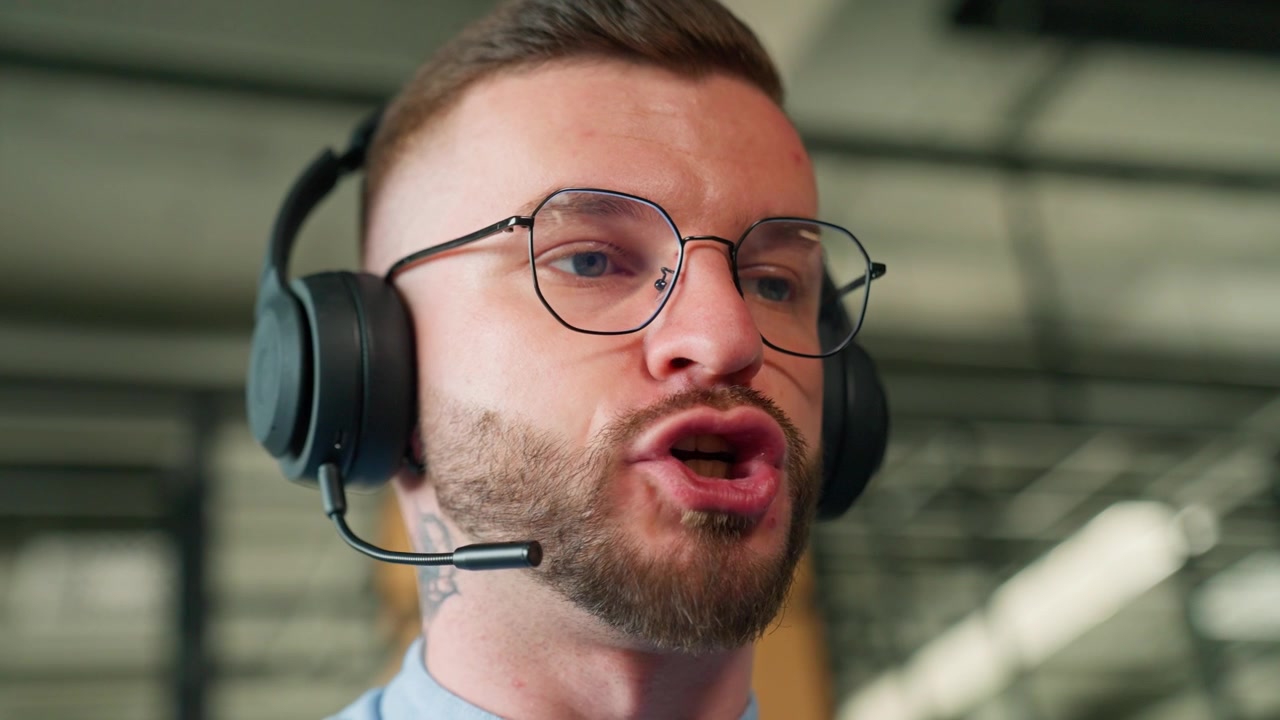 Close-up of a Professional Man Speaking with a Headset