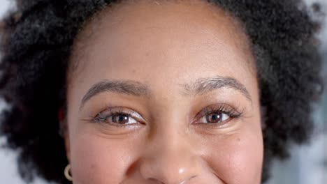 retrato de una feliz mujer médica afroamericana mirando a la cámara en el pasillo, cámara lenta