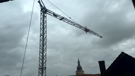 Girando-La-Grúa-En-El-Sitio-De-Construcción-Contra-El-Cielo-Nublado