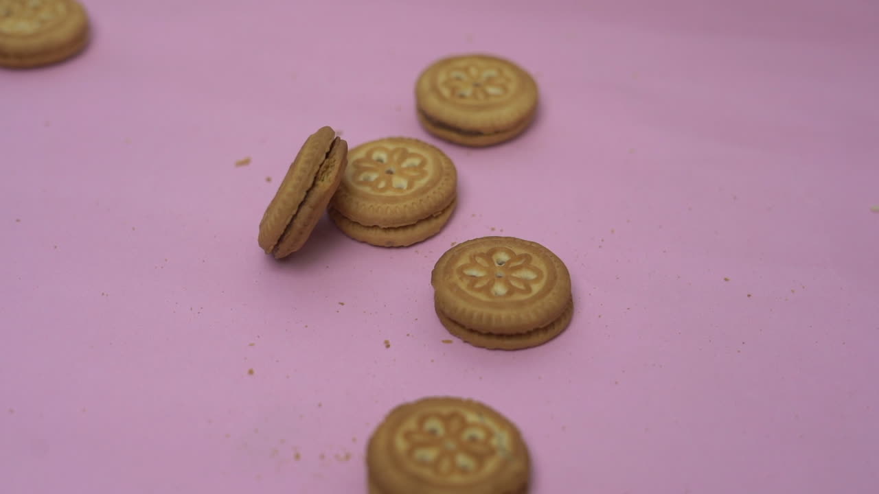 fondo rosa dejando caer galletas de arriba a abajo