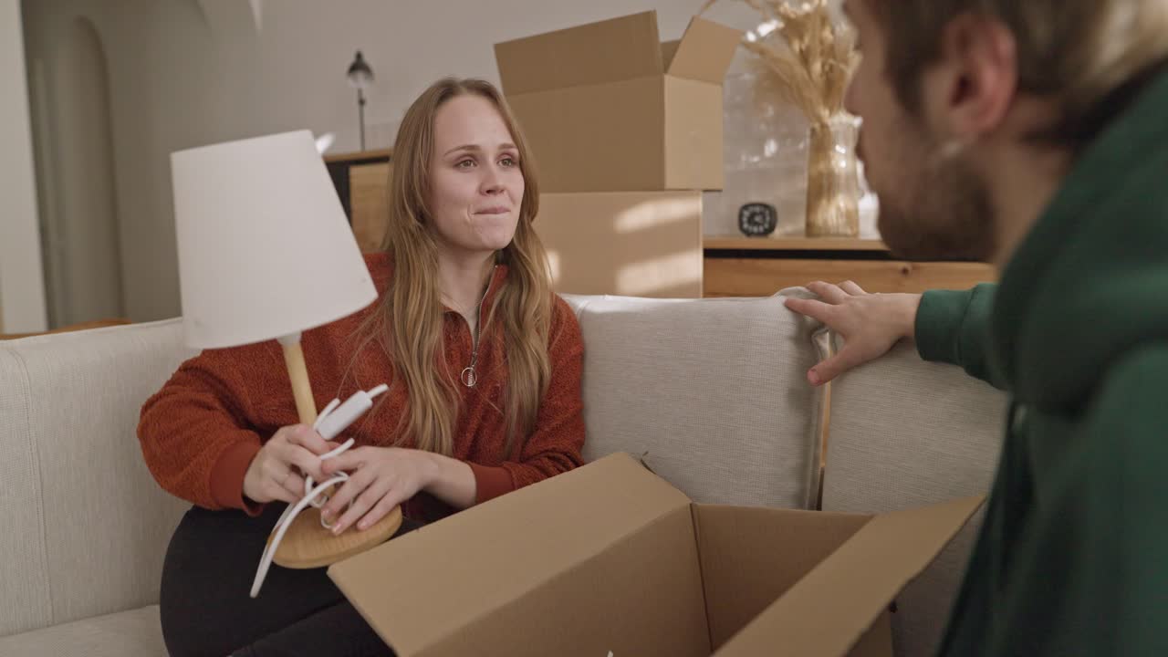 Couple Unpacking and Settling In a New Home