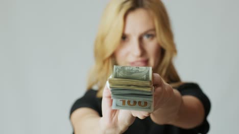 beautiful girl with a lot of dollars in the hands on the white background