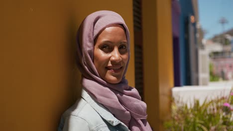 young woman wearing hijab out and about in the city